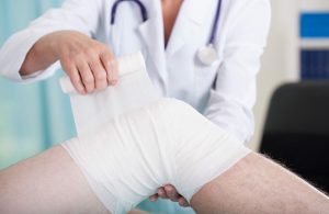 knee being wrapped after a car accident injury