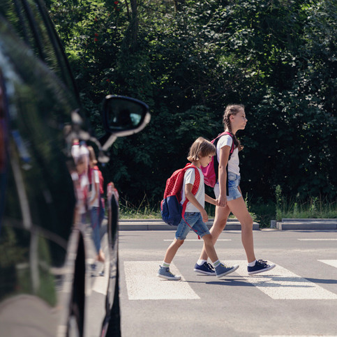 two children crossing the road