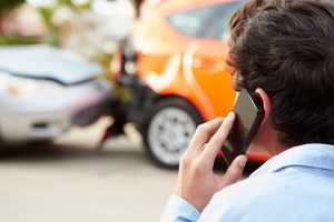 driver on the phone after a car accident